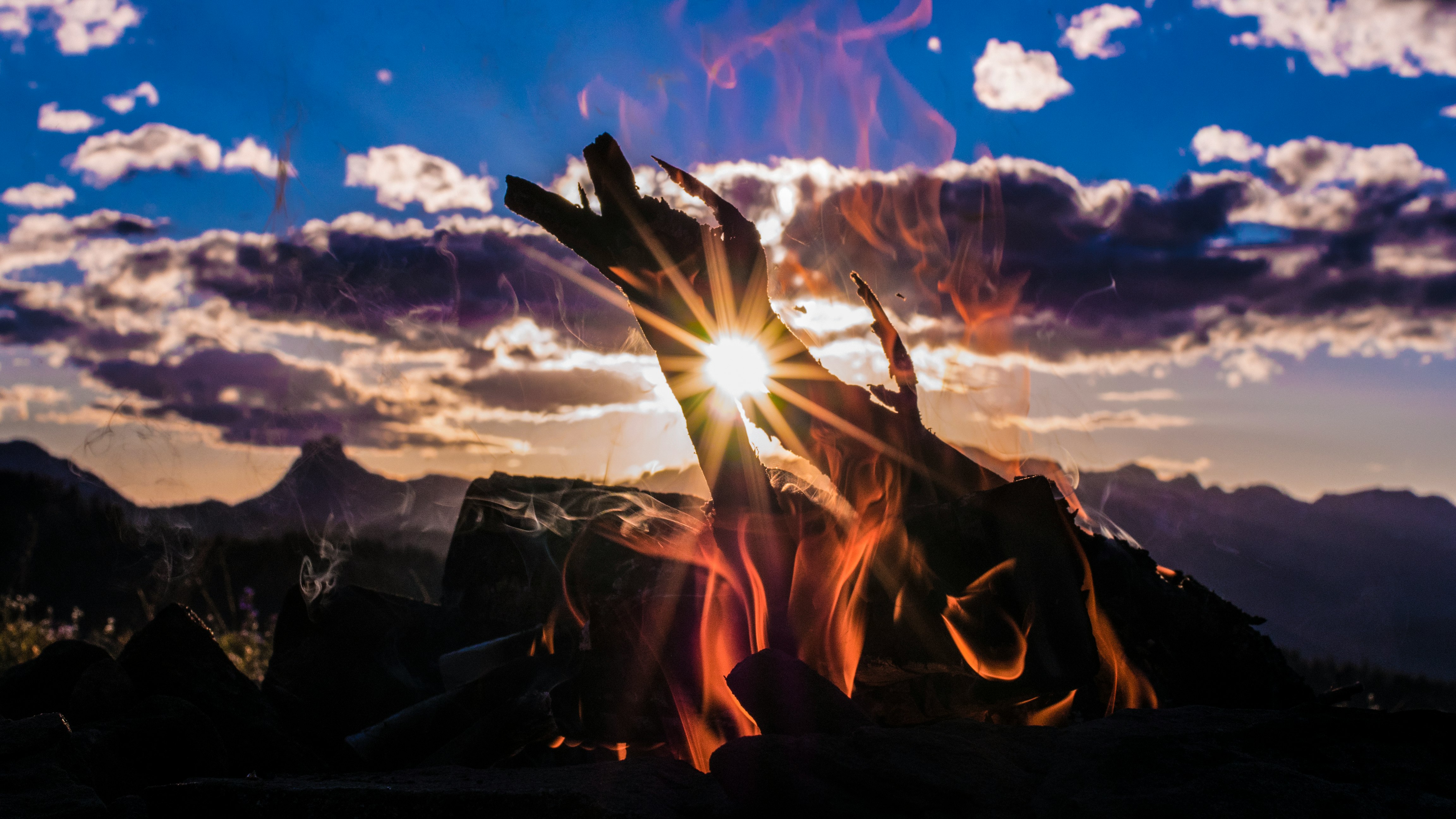 bone fire beside mountain with cloudy sky